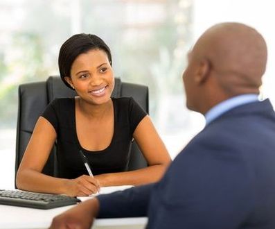 Smiling African American Agent looking at her client - Indepenedent Insurance Agency Consultation Advice